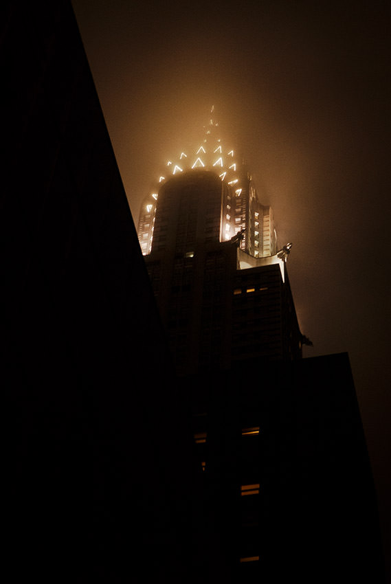 The Chrysler Building at night in the fog.