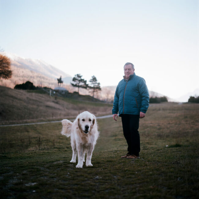 Portrait of Patrick and his dog on the meadow of the Encounter.